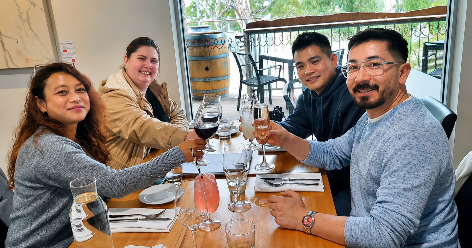 Guests raising a glass together on a winery deck during a Barossa Wine Tours day out